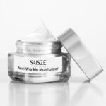 SAISZE anti-wrinkle moisturizer in an open glass jar with a silver lid.