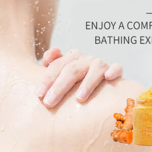 Turmeric scrub jar beside turmeric roots and a person washing their shoulder.