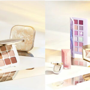 Open eyeshadow palettes and makeup products displayed on reflective white shelves.