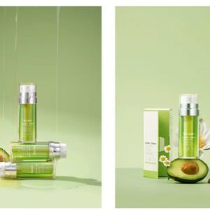 Green cleansing oil bottles and packaging beside avocado halves.