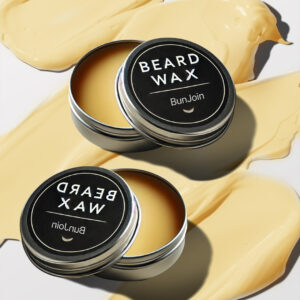 Two BunJoin beard wax tins displayed on swirls of yellow wax.