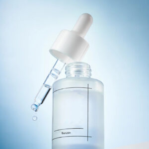 Clear serum bottle with a white dropper and a suspended droplet.