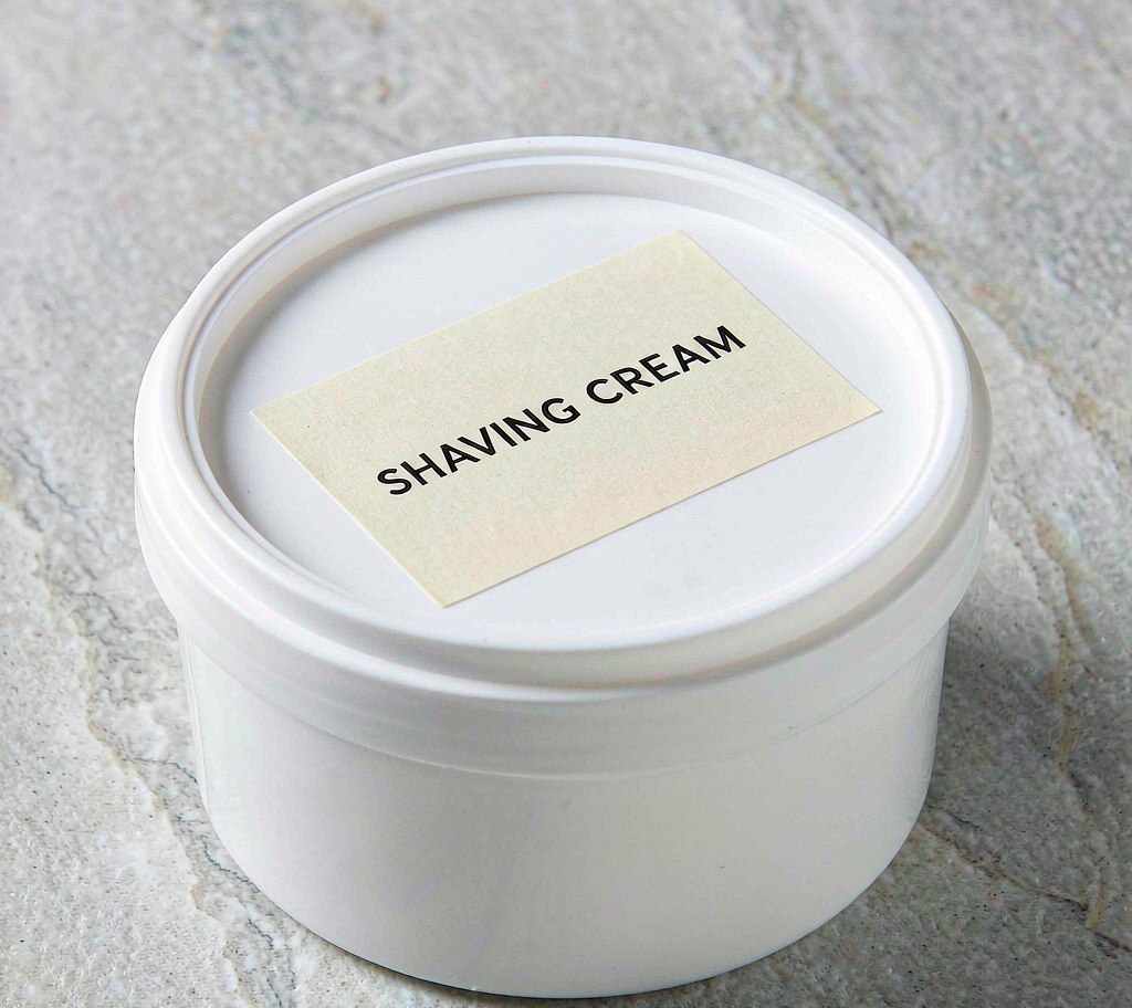 Shaving cream tub with product label on lid